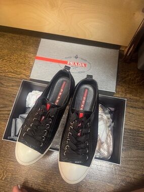 Prada Black Leather Low-Top Sneakers with White Toe Caps and Red Accents